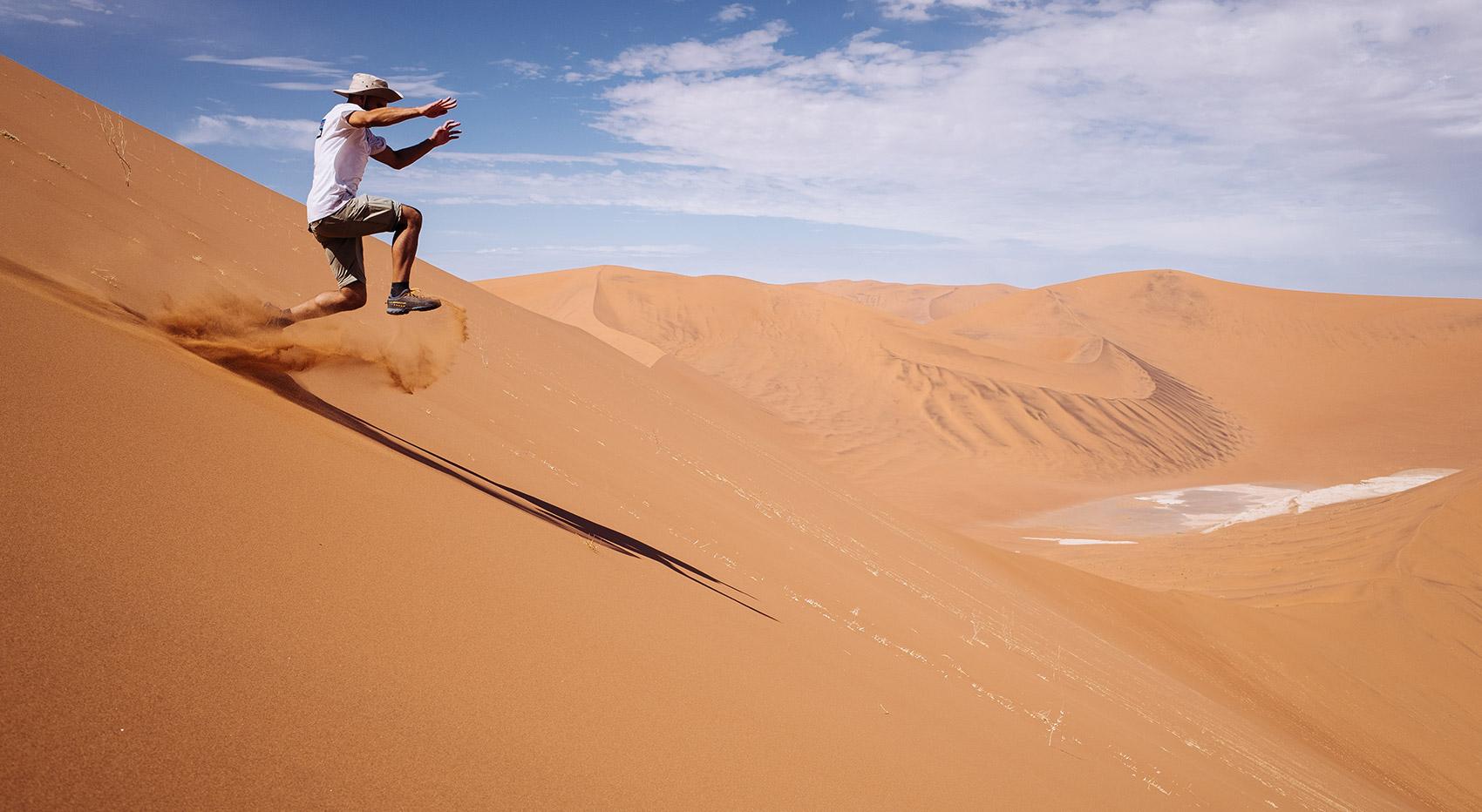 Mann springt Big Daddy Dune in Deadvlei hinunter Mann springt Big Daddy Dune in Deadvlei hinunter