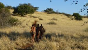 San Bushmen walking near Bagatelle Game Ranch in Namibia's Kalahari