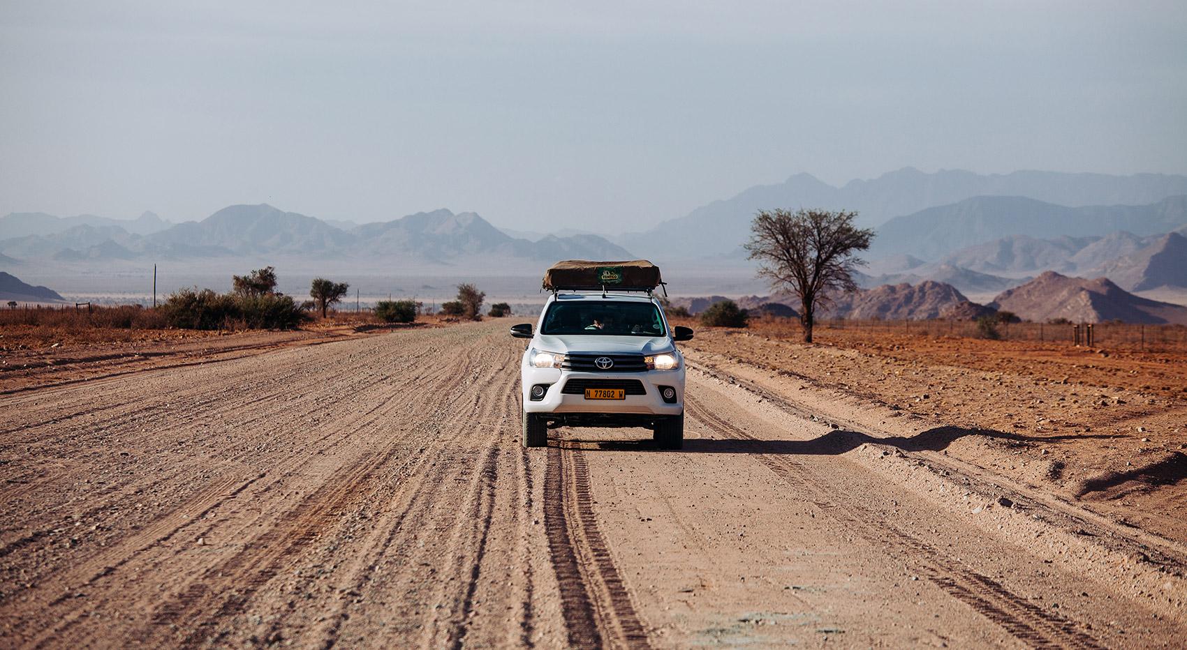 Rental car with roof top tent on dirt road in Namibia Rental car with roof top tent on dirt road in Namibia