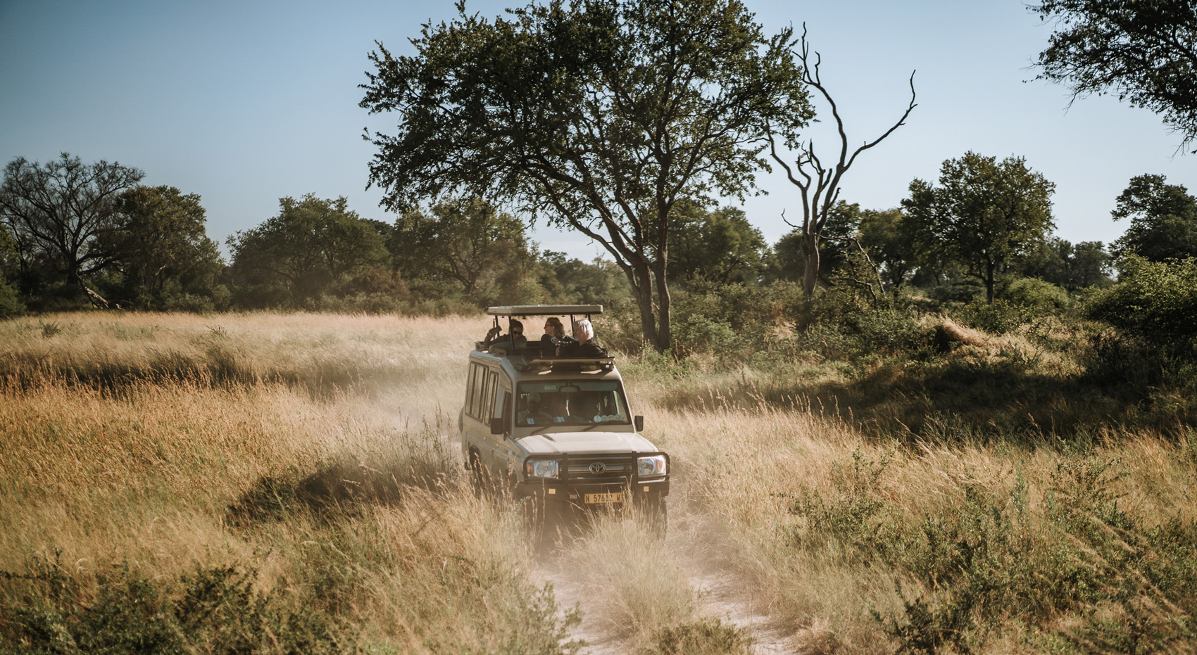 A Namibia-Experience safari vehicle with guests in it.
