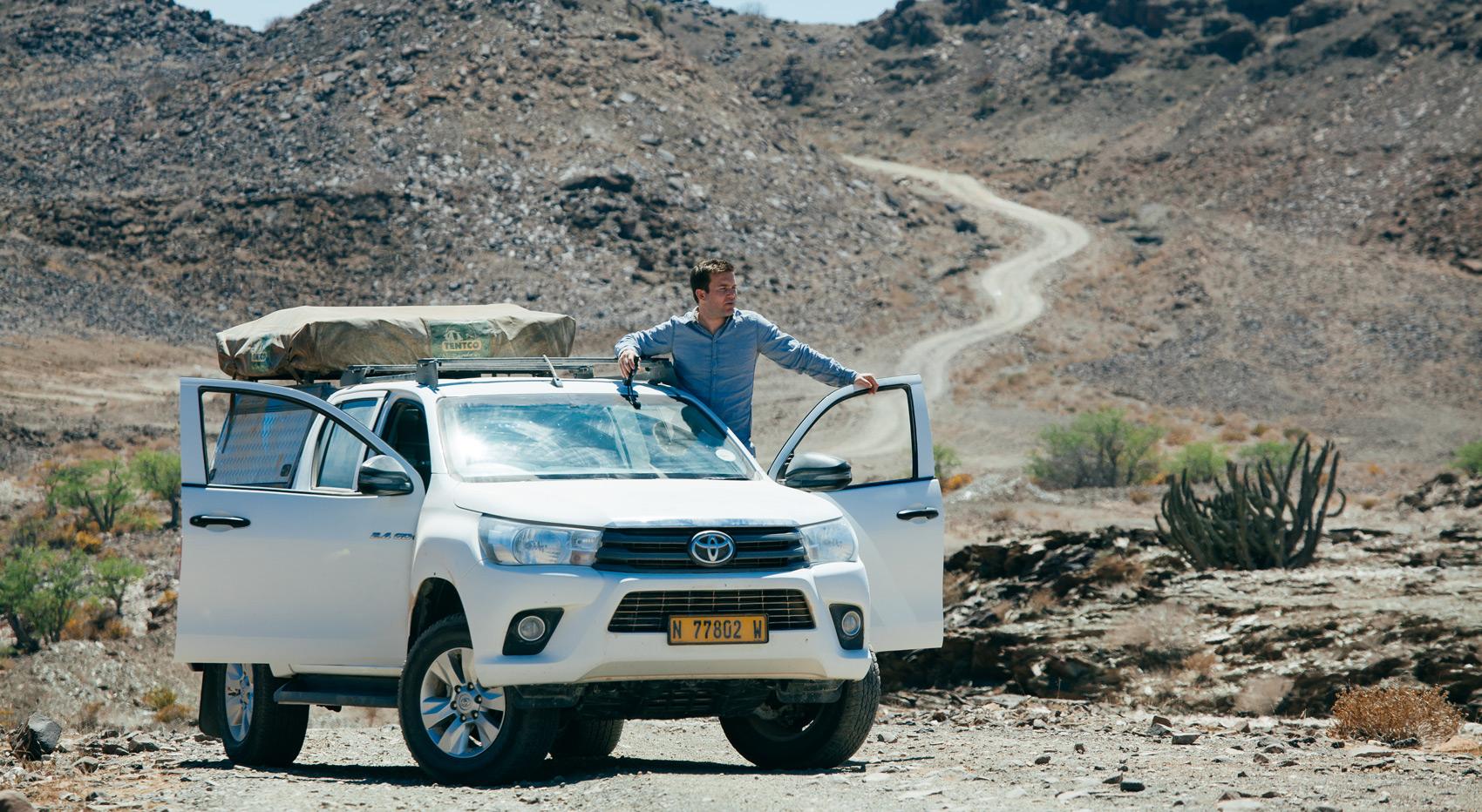 A self-drive tourist in Namibia getting out and enjoying the view. 