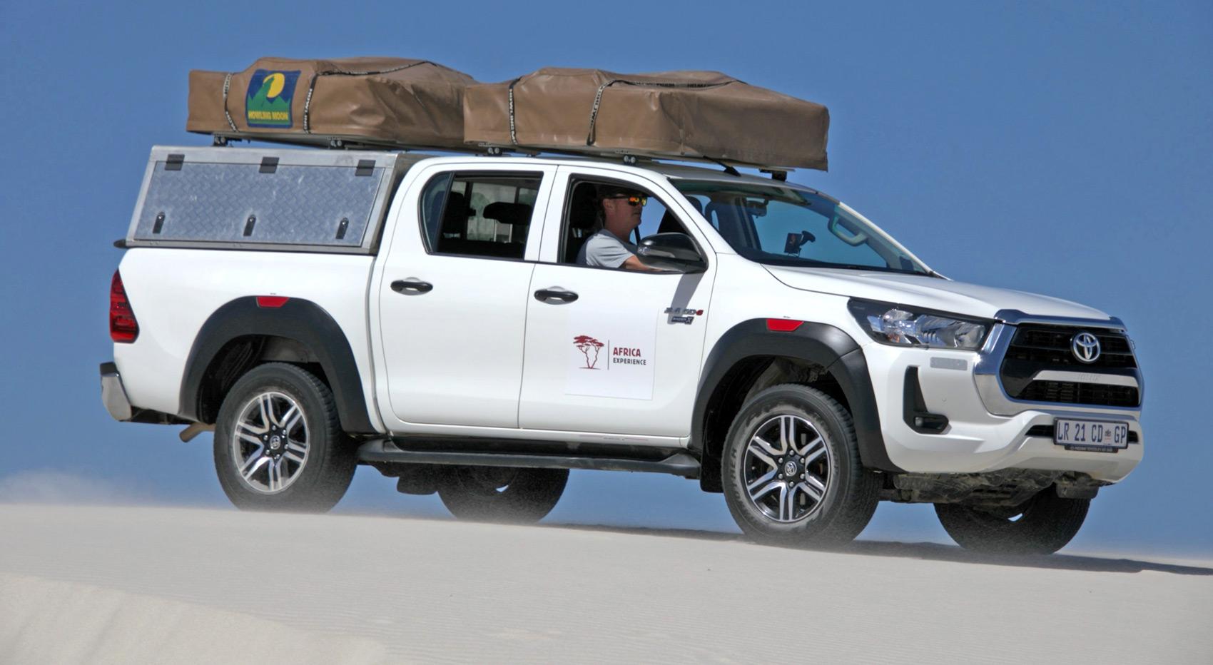 A Afrika-Experience guided self-drive vehicle driving on sand.