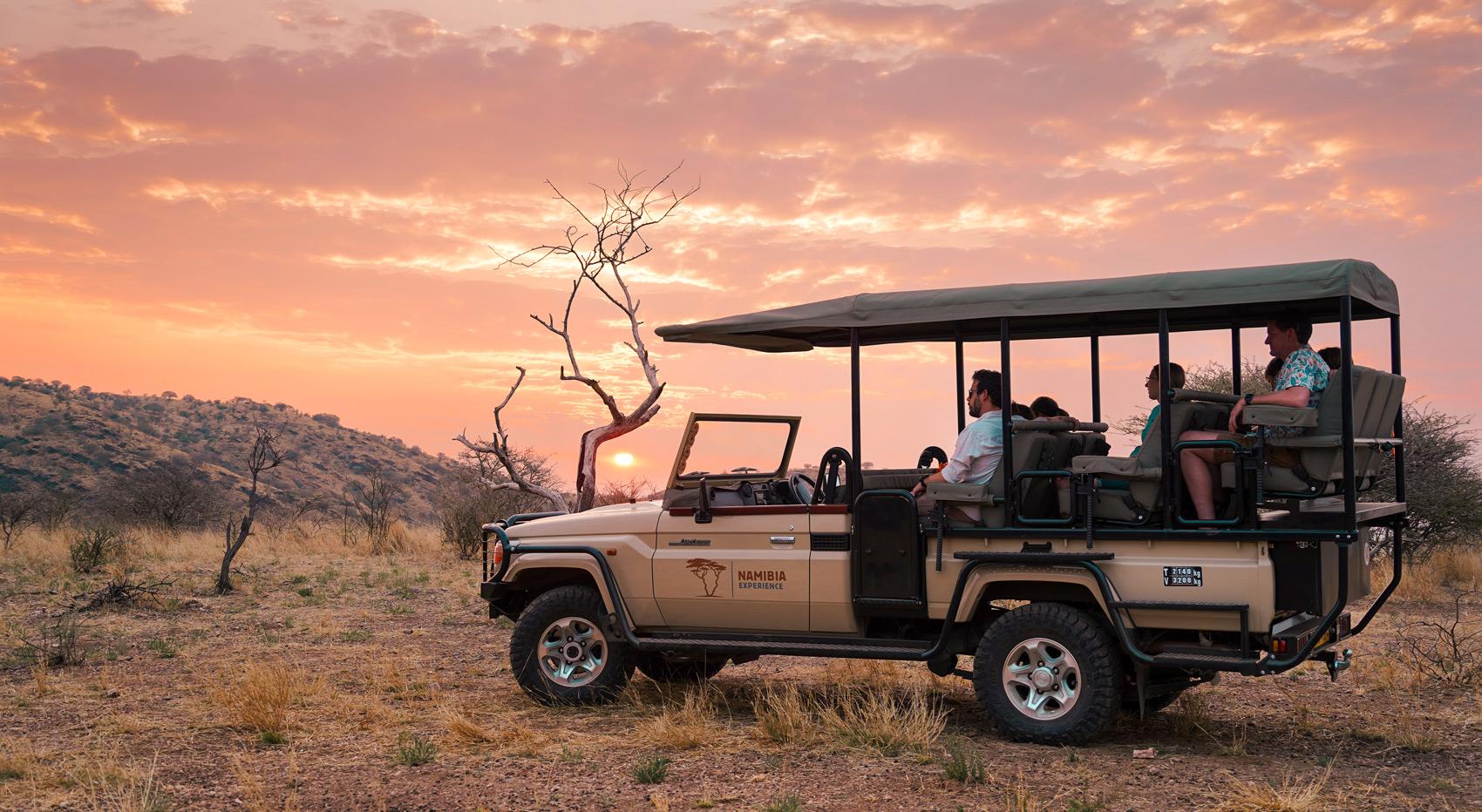 Guests in an open game drive vehicle in Etosha, Namibia