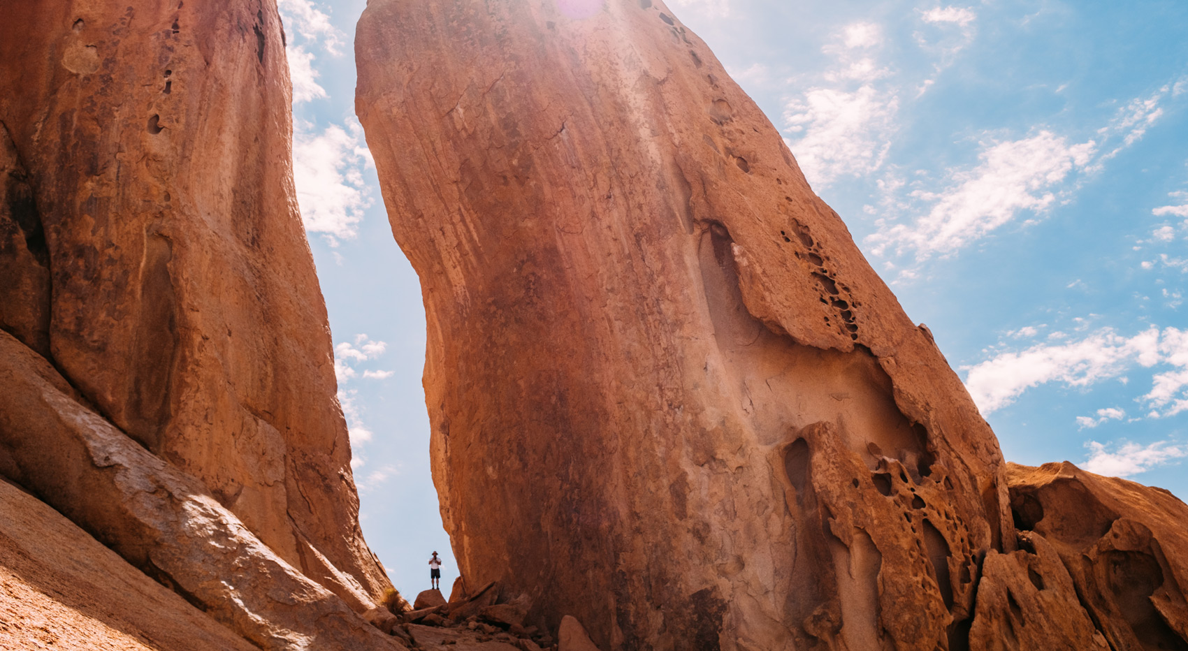 A hiker between rock formations in Namibia.