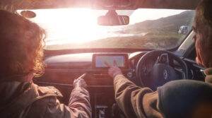 A couple sitting in the car discussing their route,