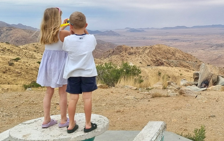 Children in Namibia taking photos at a look-out in the Namib Desert.