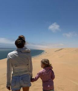 A mother and daughter overlooking the sand and ocean near Swakopmund.