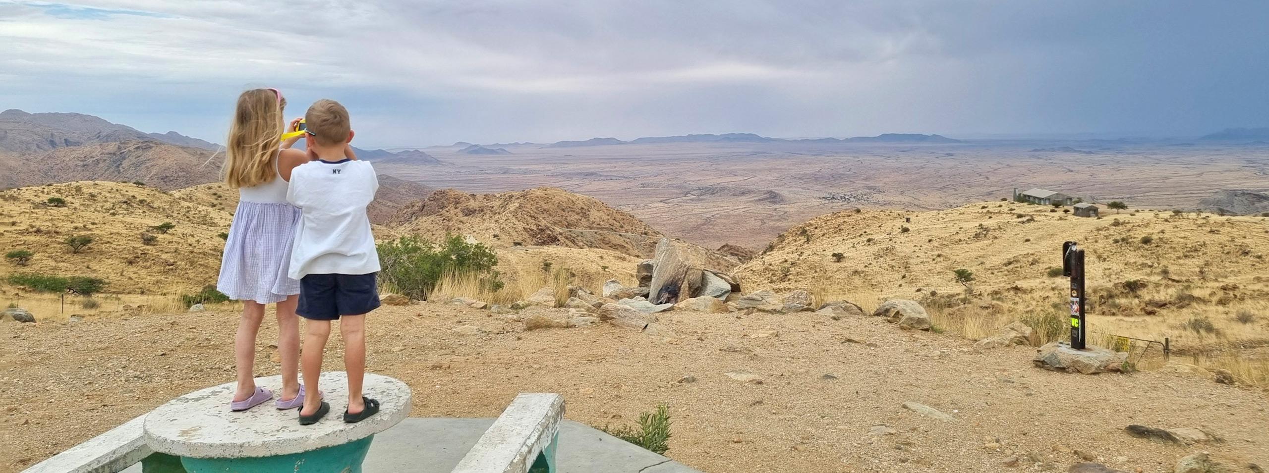 Children in Namibia taking photos at a look-out in the Namib Desert.