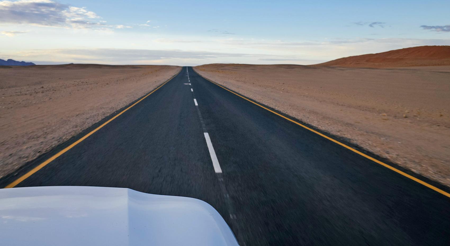 An image of the open road in Namibia, taken from within the vehicle. An image of the open road in Namibia, taken from within the vehicle.